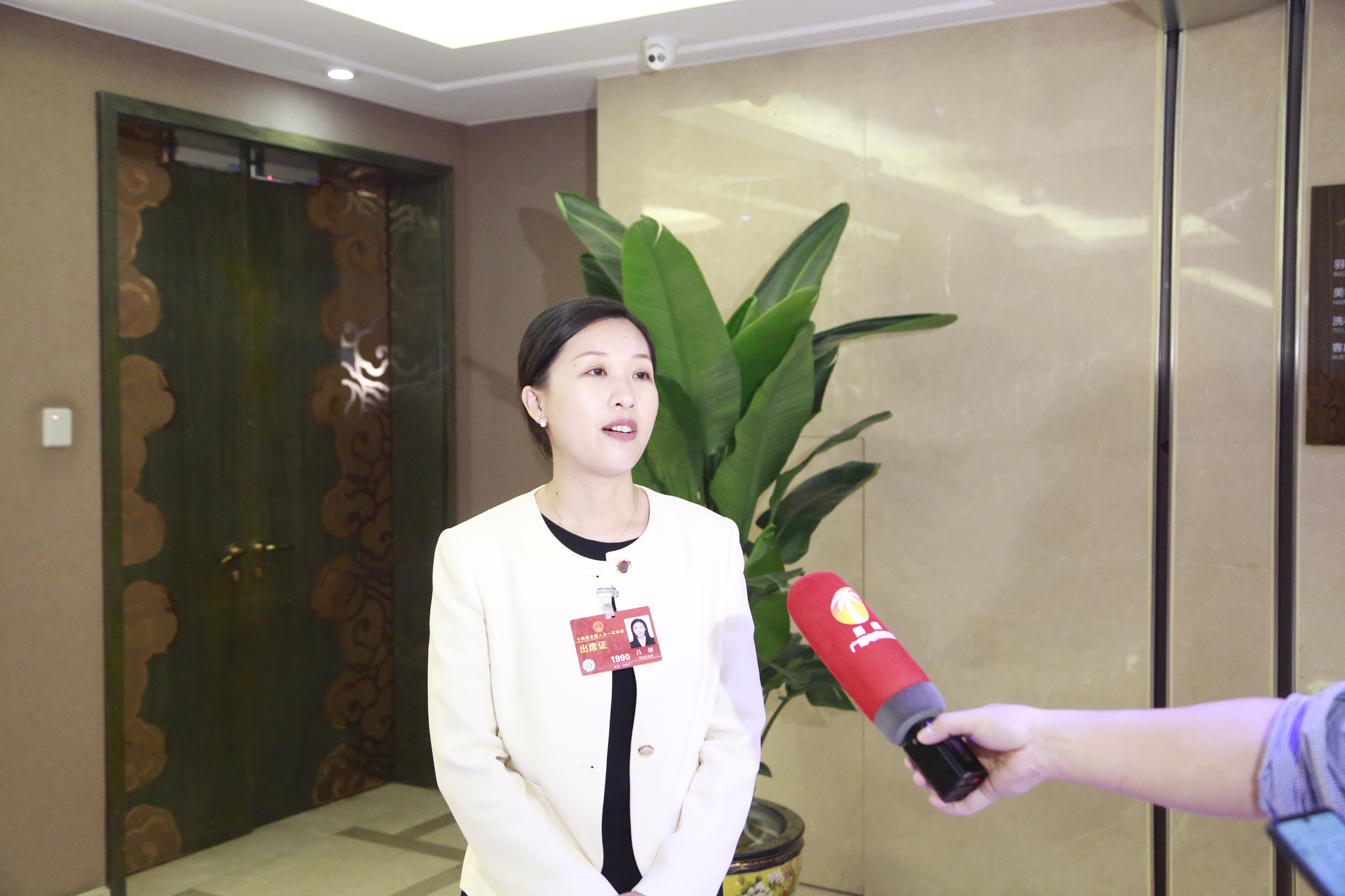 3月8日上午，海南代表团在住地审议全国人大常委会工作报告，图为吕妍代表接受电视台采访 张旭图